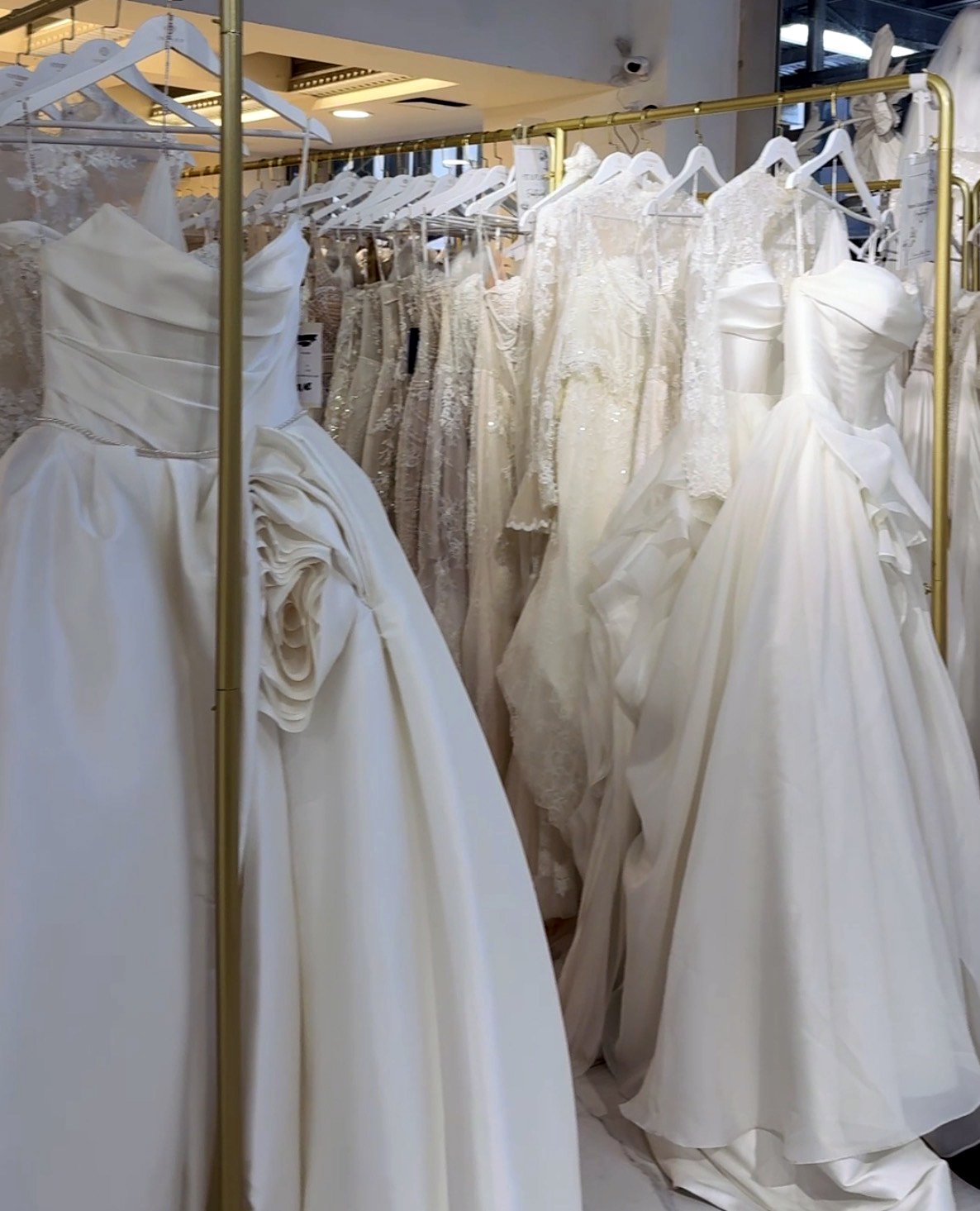 Rack of bridal gowns at a bridal salon, ready for a styling appointment